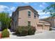 Exterior of a two-story home with a two-car garage, desert landscaping, and stucco facade at 4610 Lime Straight Dr, Las Vegas, NV 89115