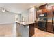 An open-concept kitchen with granite countertops, tile floors and stainless sink at 4610 Lime Straight Dr, Las Vegas, NV 89115