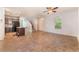 Open-concept living area featuring tile flooring, stairs, and modern kitchen with stainless steel appliances at 4610 Lime Straight Dr, Las Vegas, NV 89115