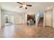 Open-concept living area with tile floors, ceiling fan, sliding glass doors, kitchen island, and stairs at 4610 Lime Straight Dr, Las Vegas, NV 89115