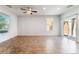 Spacious living room with tile flooring, ceiling fan, recessed lighting, and large windows at 4610 Lime Straight Dr, Las Vegas, NV 89115