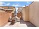 Paver patio features a stone wall and outdoor table seating with a patterned umbrella at 4610 Lime Straight Dr, Las Vegas, NV 89115