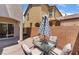 Cozy patio with stone pavers and outdoor seating with a shady umbrella at 4610 Lime Straight Dr, Las Vegas, NV 89115