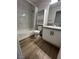 Clean bathroom with shower-tub combo, white marbled walls, and modern vanity at 5260 Mission Monterey Ln # 208, Las Vegas, NV 89107
