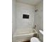 Clean bathroom showcasing modern white tile and updated showerhead fixture at 5260 Mission Monterey Ln # 208, Las Vegas, NV 89107