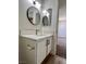 Bathroom vanity with white countertop, modern faucet, and black hardware details at 5260 Mission Monterey Ln # 208, Las Vegas, NV 89107