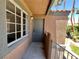 Cozy entryway with a gray door and textured stucco walls under a covered balcony at 5260 Mission Monterey Ln # 208, Las Vegas, NV 89107