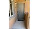Condo's front door with keyless entry and a view of the window with its white frame at 5260 Mission Monterey Ln # 208, Las Vegas, NV 89107
