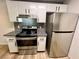 Efficient kitchen with stainless steel appliances, granite counters, and white cabinets at 5260 Mission Monterey Ln # 208, Las Vegas, NV 89107