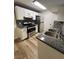 Well-lit kitchen with white cabinets, gray backsplash, stainless steel appliances and granite countertops at 5260 Mission Monterey Ln # 208, Las Vegas, NV 89107