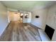 Bright living room showcases wood-look flooring and fireplace with modern marble surround at 5260 Mission Monterey Ln # 208, Las Vegas, NV 89107