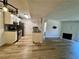 Open-concept living room features an updated kitchen and cozy fireplace with marble accents at 5260 Mission Monterey Ln # 208, Las Vegas, NV 89107