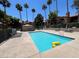 Relaxing community pool with lounge seating and tropical trees offers a serene escape at 5260 Mission Monterey Ln # 208, Las Vegas, NV 89107