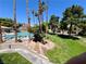 Community pool surrounded by lush landscaping, trees and greenery at 5260 Mission Monterey Ln # 208, Las Vegas, NV 89107