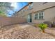 A low-maintenance backyard featuring a brick patio, rock landscaping, and block wall fencing at 5299 Silver Branch Ave, Las Vegas, NV 89118