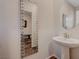 Stylish powder room featuring a pedestal sink and a decorative mirror with unique mosaic border at 5299 Silver Branch Ave, Las Vegas, NV 89118