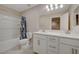 Bright bathroom with double sinks, a shower-tub combo, and modern fixtures at 5299 Silver Branch Ave, Las Vegas, NV 89118