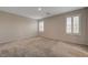 Empty carpeted bedroom with plantation shutters on windows offering plenty of natural light at 5299 Silver Branch Ave, Las Vegas, NV 89118