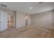Spacious carpeted bedroom featuring neutral walls, a recessed light fixture, and two doorways at 5299 Silver Branch Ave, Las Vegas, NV 89118
