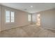 Carpeted bedroom with two bright windows with plantation shutters and access to the en suite bath at 5299 Silver Branch Ave, Las Vegas, NV 89118
