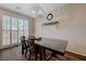 Dining room with dark wood table, chandelier, and light-filled window at 5299 Silver Branch Ave, Las Vegas, NV 89118