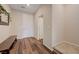 Inviting entryway with wood-look floors, a wooden bench, and a white front door at 5299 Silver Branch Ave, Las Vegas, NV 89118