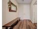 Inviting entryway with wood-look floors, a wooden bench, and a decorative mirror at 5299 Silver Branch Ave, Las Vegas, NV 89118