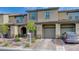 Charming two-story townhome featuring a private garage, lovely walkway, and well maintained landscaping at 5299 Silver Branch Ave, Las Vegas, NV 89118