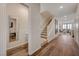Bright hallway featuring wood-look floors, a staircase, and a powder room at 5299 Silver Branch Ave, Las Vegas, NV 89118