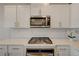 Close up of kitchen with stainless steel appliances, white countertops and cabinets at 5299 Silver Branch Ave, Las Vegas, NV 89118