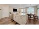 A kitchen island with sink overlooks a dining table and living area at 5299 Silver Branch Ave, Las Vegas, NV 89118