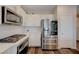 Bright kitchen with stainless steel appliances, gas range, and white cabinetry, providing a modern and functional cooking environment at 5299 Silver Branch Ave, Las Vegas, NV 89118