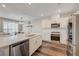 Bright kitchen features an island, stainless appliances, modern cabinetry, and wood flooring at 5299 Silver Branch Ave, Las Vegas, NV 89118