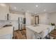 Open kitchen with an island, stainless steel appliances, and wood-look floors at 5299 Silver Branch Ave, Las Vegas, NV 89118