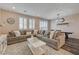 Spacious living room featuring a cozy seating area, decorative chandelier, and adjacent dining space at 5299 Silver Branch Ave, Las Vegas, NV 89118