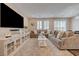 Bright and airy living room offering a comfortable seating arrangement and a large flat-screen television at 5299 Silver Branch Ave, Las Vegas, NV 89118