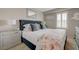 Primary bedroom features plantation shutters, contemporary nightstands and decorative mirror at 5299 Silver Branch Ave, Las Vegas, NV 89118