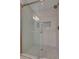 Tiled shower with glass enclosure, decorative tile accent, and bronze fixtures at 5299 Silver Branch Ave, Las Vegas, NV 89118
