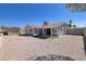 Gravel backyard featuring a covered patio and a small storage shed at 5535 Oxbow St, Las Vegas, NV 89119