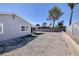 Spacious gravel backyard with block wall and partially covered patio, perfect for low-maintenance landscaping at 5535 Oxbow St, Las Vegas, NV 89119