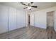 Bright bedroom featuring light wood-look flooring, ceiling fan, and closet at 5535 Oxbow St, Las Vegas, NV 89119