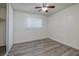 This bedroom has wood-look floors, a ceiling fan and a window at 5535 Oxbow St, Las Vegas, NV 89119