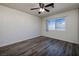 This is a bright bedroom with a ceiling fan and wood-look flooring at 5535 Oxbow St, Las Vegas, NV 89119