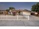 Inviting single-story home featuring desert landscaping and a charming white picket fence at 5535 Oxbow St, Las Vegas, NV 89119