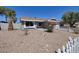 Charming single-story home featuring desert landscaping and a white picket fence at 5535 Oxbow St, Las Vegas, NV 89119