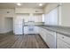 Modern kitchen with white cabinets, light granite countertops, and stainless steel appliances, with lots of natural light at 5535 Oxbow St, Las Vegas, NV 89119