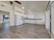 Open-concept kitchen with white cabinets, granite countertops, stainless steel appliances and updated flooring at 5535 Oxbow St, Las Vegas, NV 89119