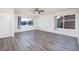 Bright living room showcasing updated flooring, large windows, and a ceiling fan at 5535 Oxbow St, Las Vegas, NV 89119