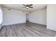 Neutral living room with updated floors, ceiling fan and a view into other parts of the home at 5535 Oxbow St, Las Vegas, NV 89119