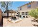 Spacious backyard features a charming pergola with a dining area and lush landscaping, perfect for outdoor living at 561 Fork Mesa Ct, Henderson, NV 89015
